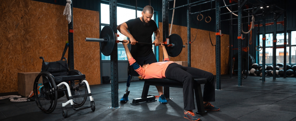 Personal trainer demonstrating correct exercise technique during a workout.